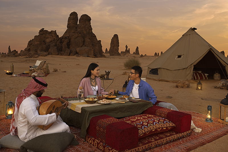 A couple having dinner in Gharameel of Al-Ula at sunset. arab saudi